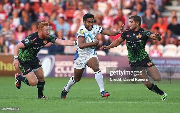 George Wacokecoke of Bath moves between Joel Conlon and Rob Coote of Exeter during the Premiership Rugby 7's Series at Kingsholm Stadium on July 31,...