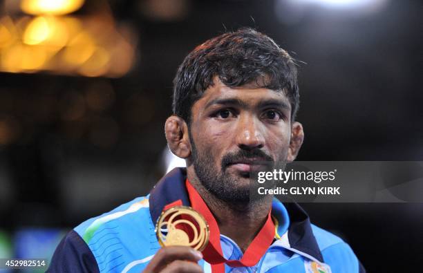Gold medalist Yogeshwar Dutt of India poses with his medal after the Men's Freestyle 65kg Freestyle Wrestling Gold medal match at the SECC, 2014...