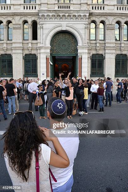 Man wearing a skullcap and a woman look on as people take part in a demonstration called by the Representative Council of Jewish Institutions in...