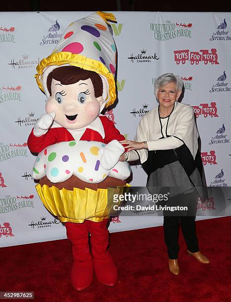 Writer Carol Aebersold poses with 'Elf on a Shelf' character at the Hollywood Christmas Parade benefiting the Toys for Tots Foundation on December 1,...