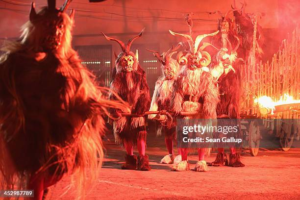 Members of the Haiminger Krampusgruppe dressed as the Krampus creature parade on the town square during their annual Krampus night in Tyrol on...
