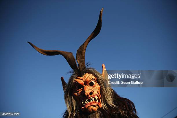 Member of the Haiminger Krampusgruppe dressed as the Krampus creature arrives prior to the annual Krampus night in Tyrol on December 1, 2013 in...