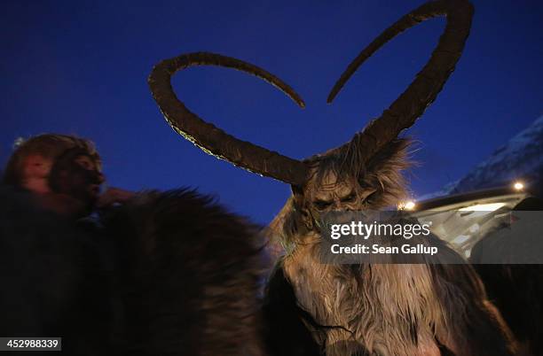 Participant who arrived by bus tries on his Krampus creature mask as other participants put on their costumes prior to Krampus night on November 30,...