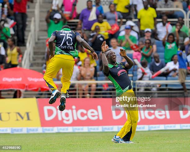 Jerome Taylor and Andre Russell of Jamaica Tallawahs celebrates the dismissal of Marlon Samuels of Antigua Hawksbills during a match between Jamaica...