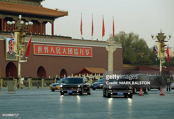 British Prime Minister David Cameron is driven past the portrait of late Chinese leader Mao Zedong in a Chinese-made Hongqi limousine at Tiananmen...