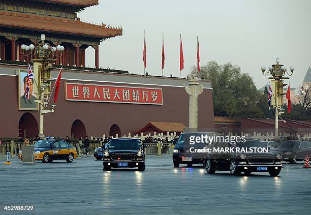 British Prime Minister David Cameron is driven past the portrait of late Chinese leader Mao Zedong in a Chinese-made Hongqi limousine at Tiananmen...