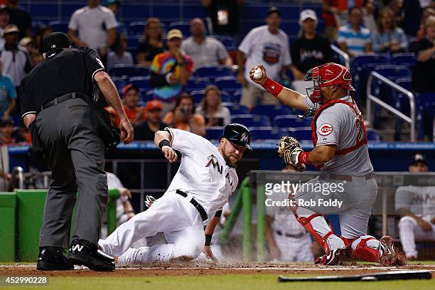Brayan Pena of the Cincinnati Reds reacts after tagging out Casey McGehee of the Miami Marlins at home plate during the first inning of the game at...