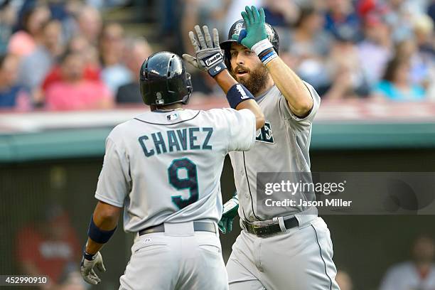 Endy Chavez celebrates with Dustin Ackley of the Seattle Mariners after Ackley hit a two run home run during the third inning against the Cleveland...