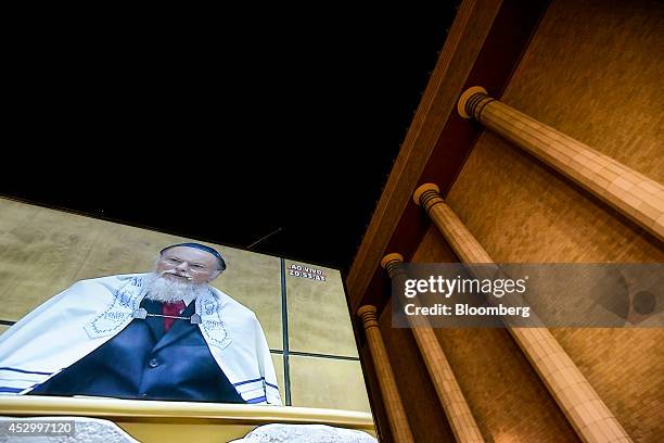 Billionaire Edir Macedo, owner and chairman of Rede Record de Televisao Angola Lda, is projected on a screen displayed outside a replica of Solomon's...
