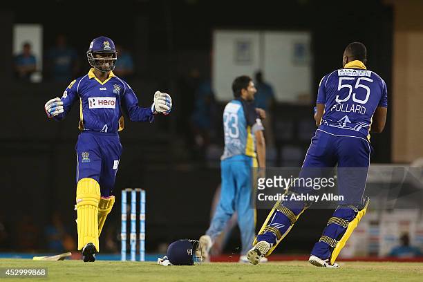 Akeal Hosien and Kieron Pollard celebrate winning during a match between St. Lucia Zouks and Barbados Tridents as part of week 4 of the Limacol...
