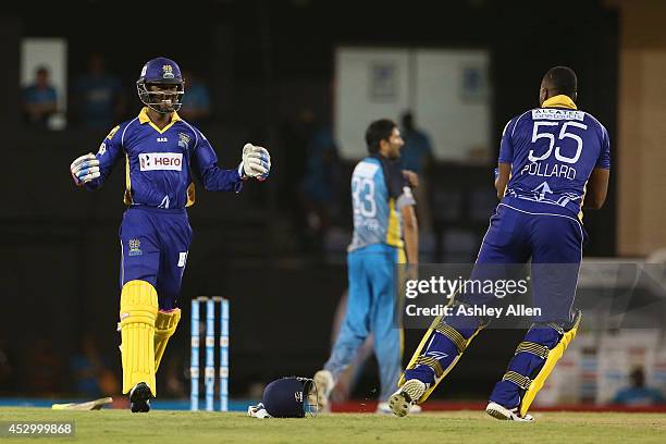 Akeal Hosien and Kieron Pollard celebrate winning during a match between St. Lucia Zouks and Barbados Tridents as part of week 4 of the Limacol...