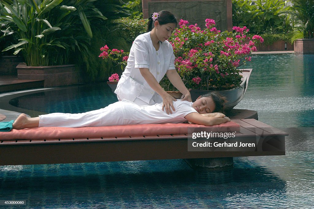 A young woman receives a Thai massage at Aspara Spa at the...