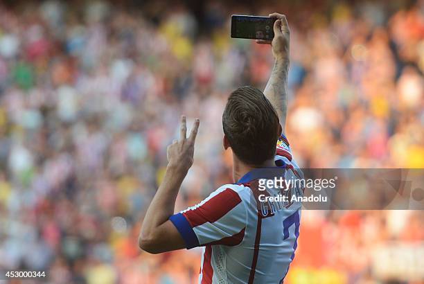 Atletico Madrid's new player French Antoine Griezmann takes a selfie during his official presentation at the Vicente Calderon stadium in Madrid,...