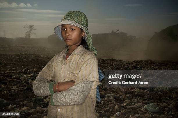 Sun Sok Jeng, 13 years old, works full time at the dump, and earns USD 1 a day. She has been here for over one year. She has found all her clothes at...