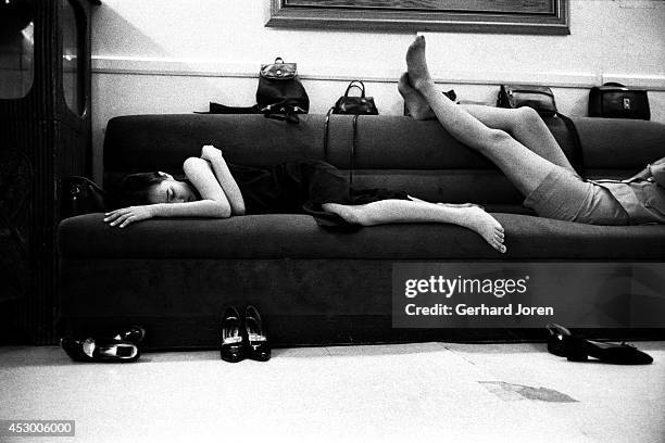 Late at night, some young prostitutes who didn't get taken by clients, catch up on sleep on a sofa at the brothel where they work. At least fifty...
