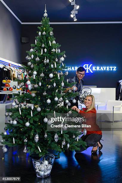 Fashion designer Richard Kravetz and TV host Nadine Krueger pose during a photo session in front of a christmas tree on December 01, 2013 in Berlin,...