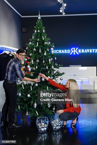 Fashion designer Richard Kravetz and TV host Nadine Krueger pose during a photo session in front of a christmas tree on December 01, 2013 in Berlin,...