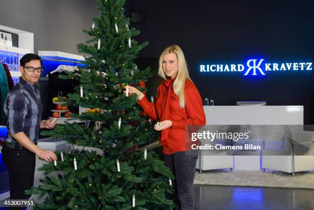 Fashion designer Richard Kravetz and TV host Nadine Krueger pose during a photo session in front of a christmas tree on December 01, 2013 in Berlin,...