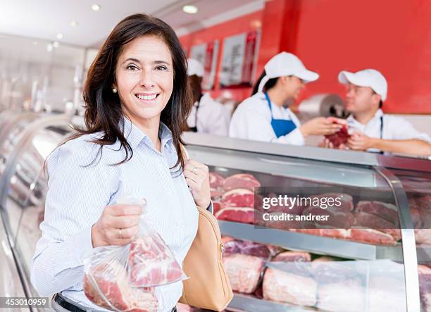 woman at the butchers - deli counter stockfoto's en -beelden