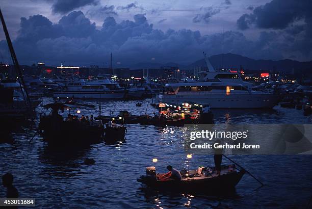 Floating restaurants in the Causeway Bay typhoon shelter on Victoria Island in Hong Kong. Vendors sell food from small boats as a unique dining...