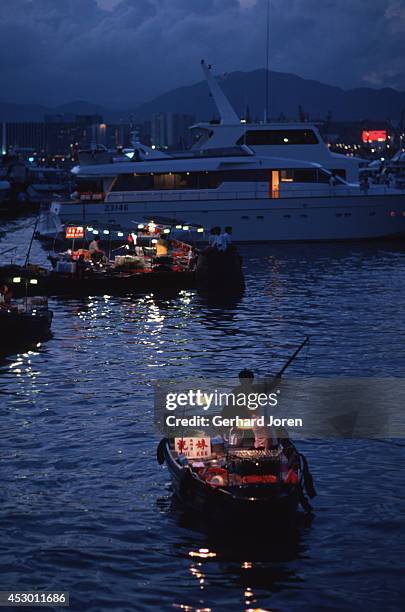 Floating restaurants in the Causeway Bay typhoon shelter on Victoria Island in Hong Kong. Vendors sell food from small boats as a unique dining...