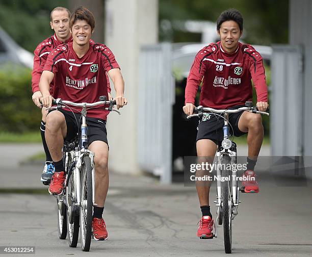 Hiroki Sakai and Hiroshi Kiyotake of Hanover ride bicycles at Hannover 96 training camp on August 1, 2014 in Mureck, Austria.