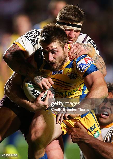 Kieran Foran of the Sea Eagles is tackled by Josh McGuire and Sam Thaiday of the Broncos during the round 21 NRL match between the Manly-Warringah...