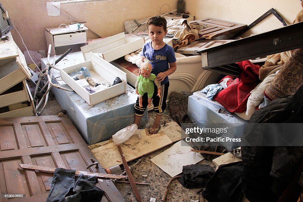 A Palestinian kid recovering his toy in his destroyed house...