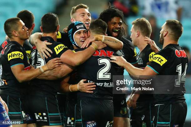 The Panthers celebrates a try by Josh Mansour during the round 21 NRL match between the Canterbury Bulldogs and the Penrith Panthers at ANZ Stadium...