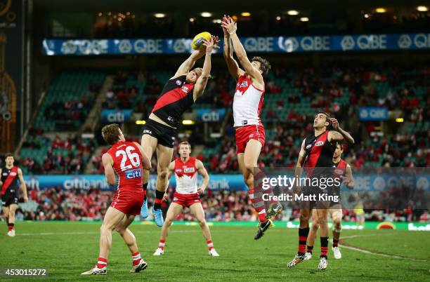 Michael Hurley of the Bombers is challenged by Kurt Tippett of the Swans during the round 19 AFL match between the Sydney Swans and the Essendon...