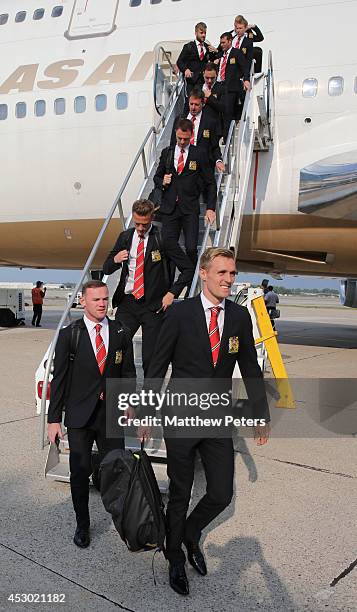 Darren Fletcher and Wayne Rooney of Manchester United arrives in Detroit as part of their pre-season tour of the United States on July 31, 2014 in...