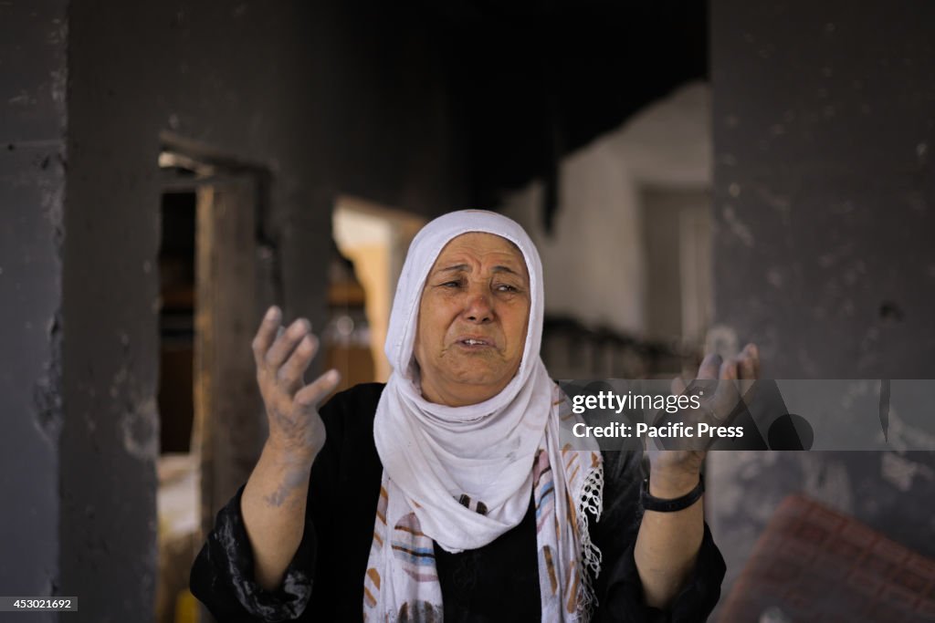 Palestinian woman cries upon seeing her ruined home in Beit...