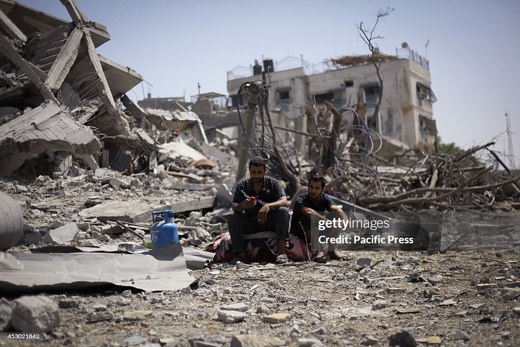 Palestinians inspect their ruined home in Beit Hanoun in the...