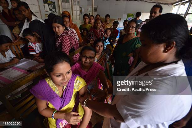 An Indian girl receives vaccine against Japanese encephalitis in the Nagaon, 180km East of Guwahati. Vaccines are urgently needed in Assam to stop...