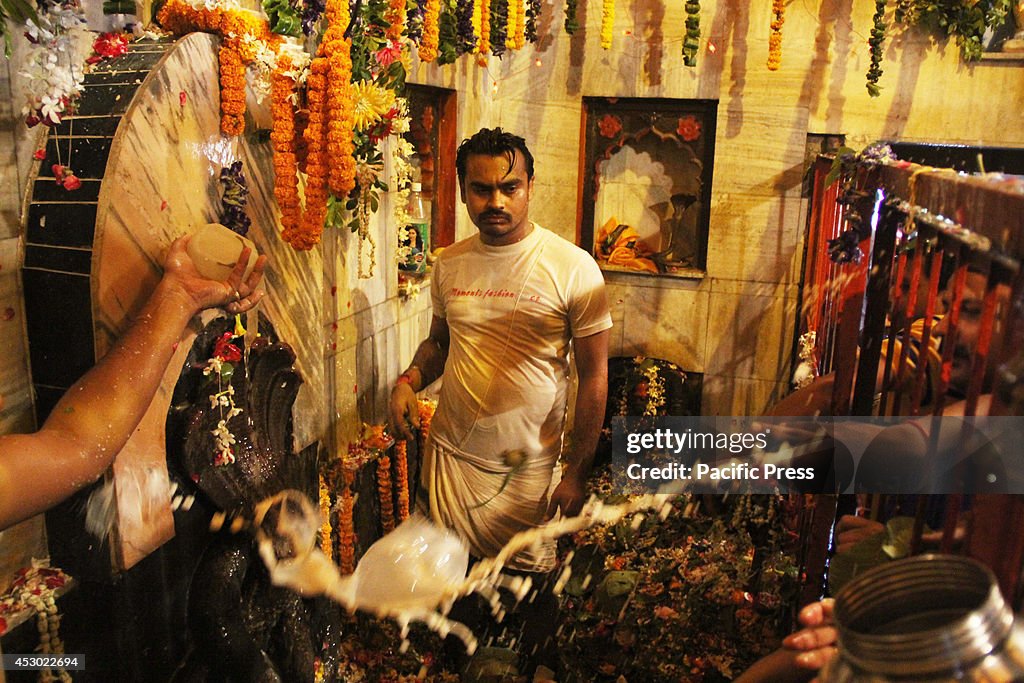 Hindu devotees gather to offer prayers and perform "...