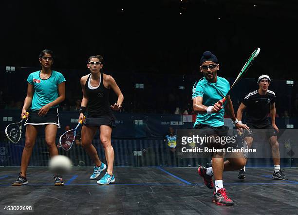 Harinder Pal Sandhu of India plays a shot in his mixed doubles match againsts Martin Knight and Joelle King of New Zealand at Scotstoun Sports Campus...