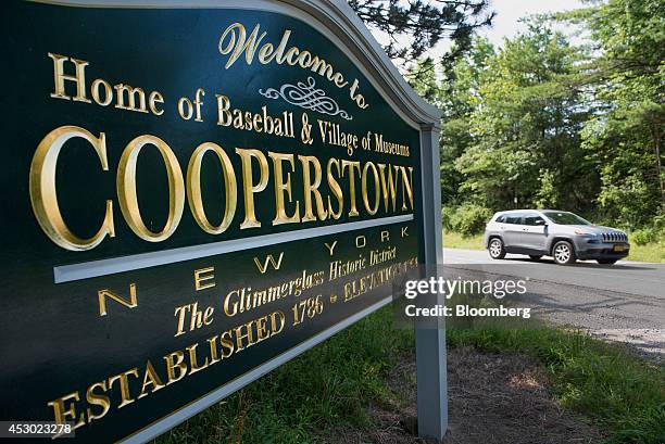 Car drives past a sign welcoming visitors in Cooperstown, New York, U.S., on Saturday, July 26, 2014. President Obama, during a visit to Cooperstown...