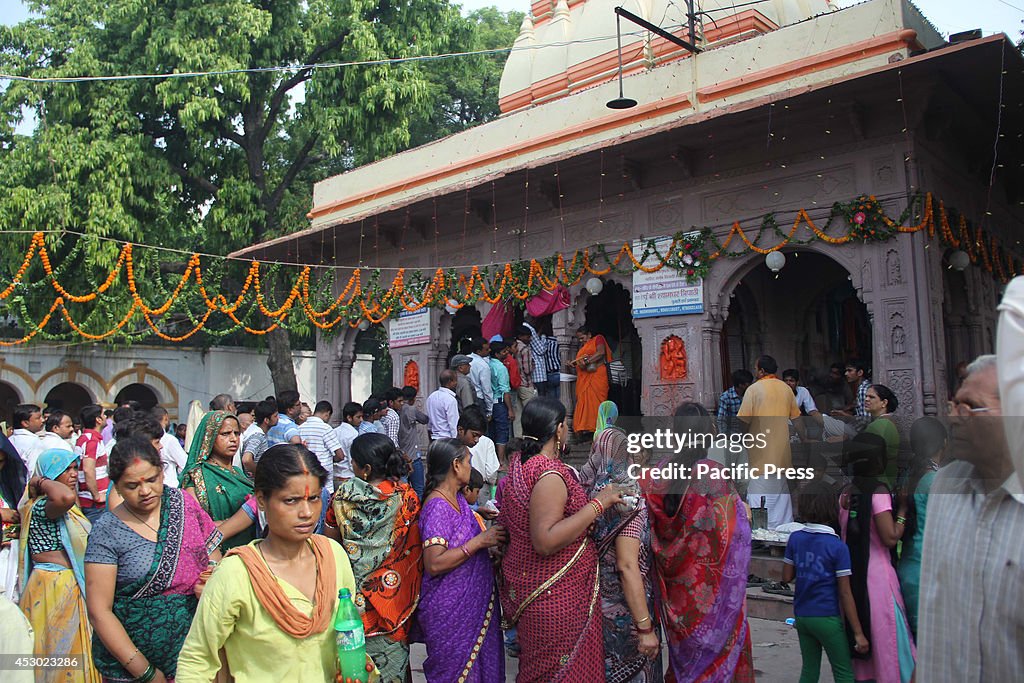 Hindu devotees gather to offer prayers and perform "...