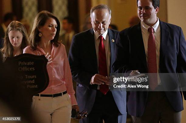 Rep. Steve King and Rep. Michele Bachmann pass through the Statuary Hall after a vote on the floor August 1, 2014 on Capitol Hill in Washington, DC....