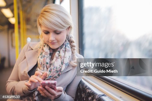 Woman using smart phone in subway Woman using smart phone in subway