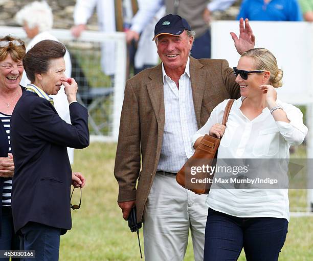 Zara Phillips looks on as her mother Princess Anne, The Princess Royal and father Mark Phillips share a joke during day 1 of the Festival of British...