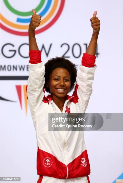 Gold medalist Jennifer Abel of Canada celebrates during the medal ceremony for the Women's 1m Springboard Final at Royal Commonwealth Pool during day...