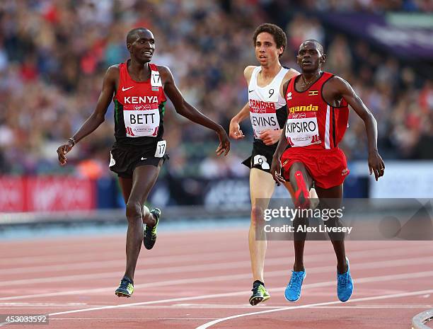 Moses Kipsiro of Uganda crosses the line to win gold ahead of Silver medalist Josphat Kipkoech Bett of Kenya and Bronze medalist Cameron Levins in...