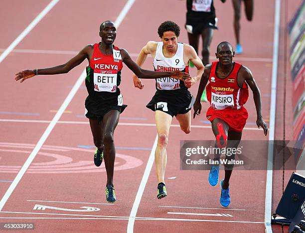 Moses Kipsiro of Uganda crosses the line to win gold ahead of Silver medalist Josphat Kipkoech Bett of Kenya and Bronze medalist Cameron Levins in...