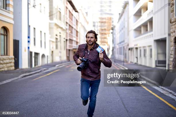 racing to get the first photo - man facing camera stock pictures, royalty-free photos & images