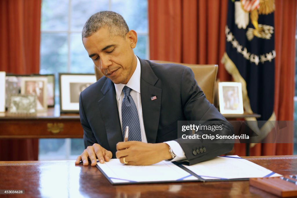 President Obama Holds Bill Signing In Oval Office Of White House