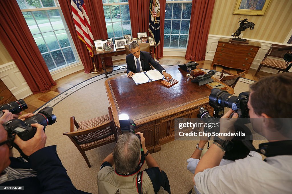 President Obama Holds Bill Signing In Oval Office Of White House