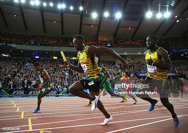 Usain Bolt of Jamaica competes in the Men's 4x100 metres relay heats at Hampden Park during day nine of the Glasgow 2014 Commonwealth Games on August...