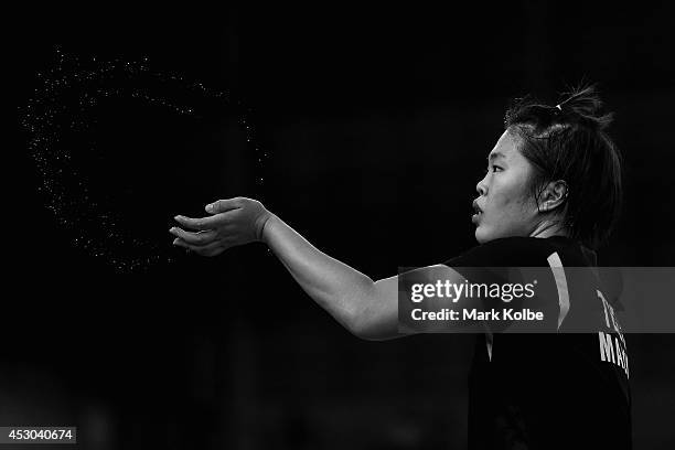 Jing Yi Tee of Malaysia flicks away sweat as she competes in her women's singles badminton quarter-final match at Emirates Arena during day nine of...