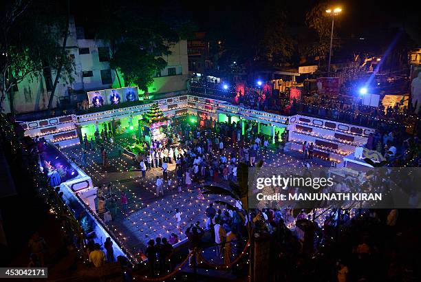 Hindu devotees light oil lamps at a temple for the Hindu God Shiva during the "Karthigai Deepam" in Bangalore on December 2, 2013. "Karthigai Deepam"...